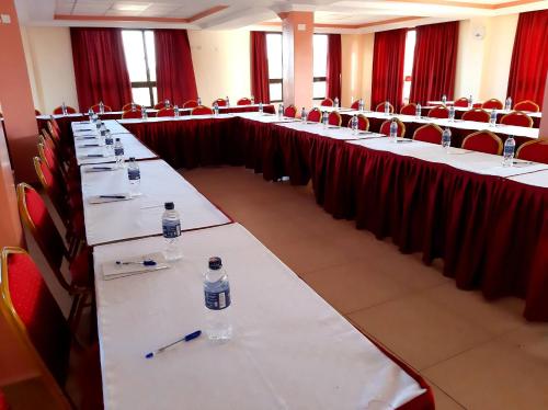 a row of tables with bottles of water on them at KILIMANI BREEZE HOTEL in Wote