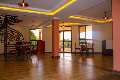 a room with a table and chairs and a dining room at KILIMANI BREEZE HOTEL in Wote