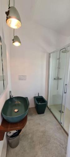 a bathroom with a green sink and a shower at Lettu di Ita - Spectacular Gallura Stazzu with sea view and pool in Santa Teresa Gallura