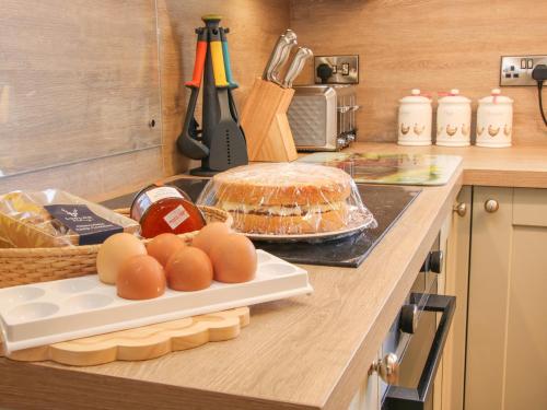 a kitchen counter with eggs and bread on a cutting board at Greenacres in Kimbolton