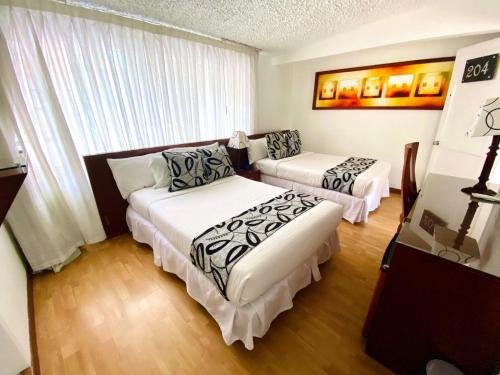 Säng eller sängar i ett rum på Hotel Marbella Chico