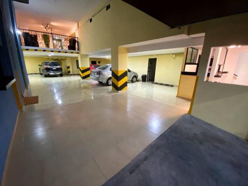 a large garage with two cars parked in it at Hotel Olé in Monterrey