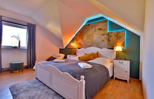a bedroom with a large bed with a stone wall at Ferienwohnung Am Wäldchen in Erfurt