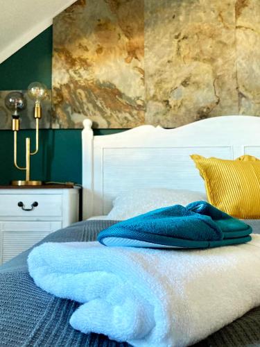 a bed with blue pillows on top of it at Ferienwohnung Am Wäldchen in Erfurt