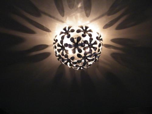 a chandelier hanging from a ceiling with rays of light at Hotel Ogliastra in Lotzorai