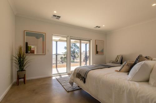 a bedroom with a large bed and a window at Brockenchack Retreat Bed & Breakfast in Mount McKenzie