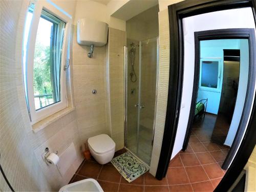 a bathroom with a shower and a toilet at Recidence Villa Olivia in Itri