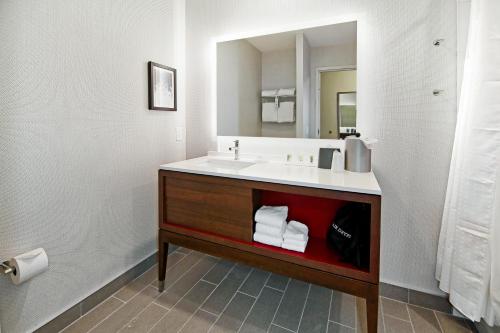 a bathroom with a sink and a mirror at Holiday Inn Hotel & Suites - Calgary Airport North, an IHG Hotel in Calgary