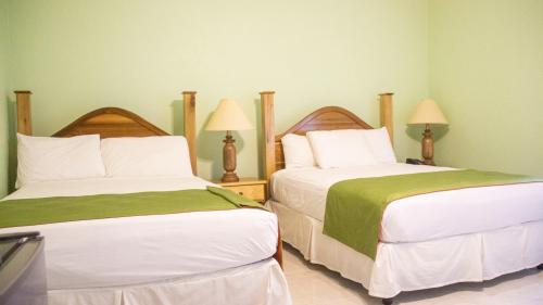 two beds sitting next to each other in a room at Holidays At Holiday Heaven in Runaway Bay