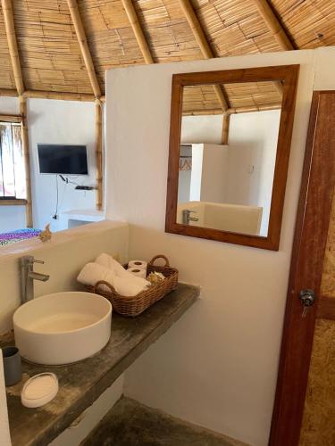 a bathroom with a sink and a mirror at Waltako Beach Culture in Canoas De Punta Sal