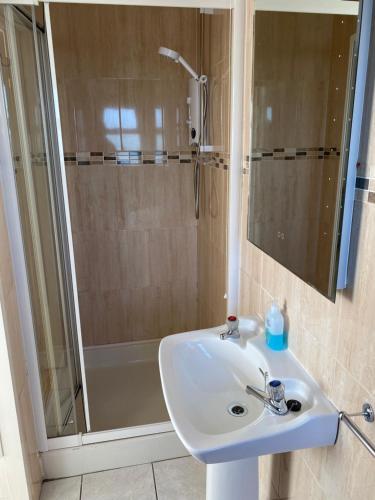 a bathroom with a sink and a shower at Cozy seaside home,3 minute walk to village/beach in Lahinch