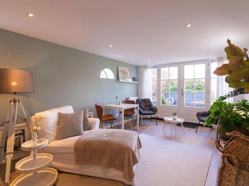 a living room with a couch and a table at Appealing Holiday Home in Medemblik with Garden in Medemblik