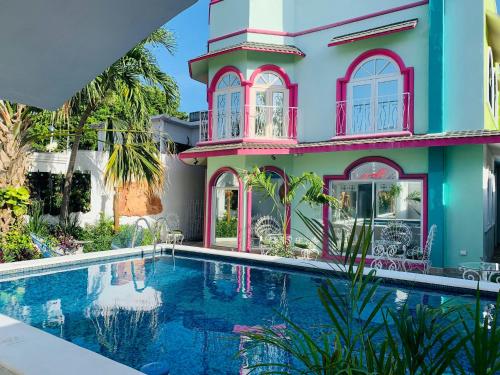 a house with a swimming pool in front of it at The Quetzal in Cancún