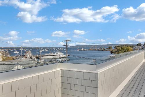 a balcony with a view of a harbor at Harbourtown Suites on Plymouth Harbor in Plymouth