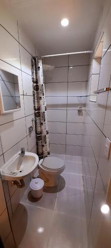 a bathroom with a toilet and a sink at LÍAH Hostel & Suites in Sao Paulo
