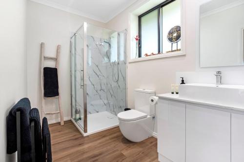 a bathroom with a shower and a toilet and a sink at Wotama, Macedon B and B, Honour Ave, Mount Macedon in Mount Macedon