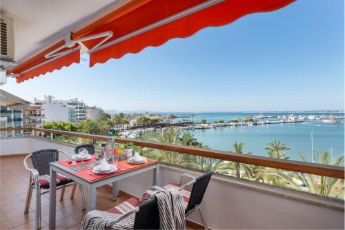 a balcony with a table and chairs and the ocean at Apartment Antonia - Alcúdia in Alcudia