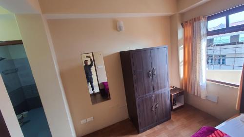 a bedroom with a cabinet and a window at Great Eastern Valley Residency in Gangtok