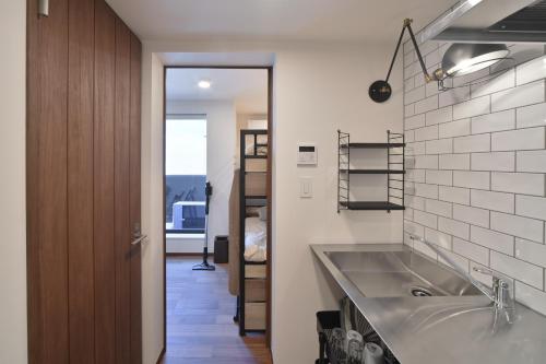 東京にあるStylewood Nishi-Shinjukuのバスルーム(大きなシンク、鏡付)