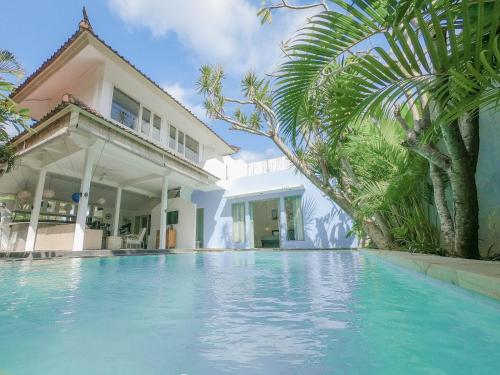 a swimming pool in front of a house at Villa Oceana I - 3BR private villa with pool in Legian