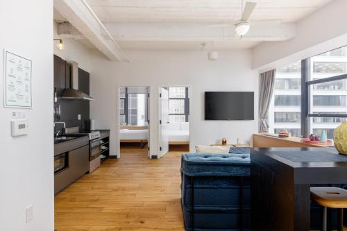 an apartment with a kitchen and a living room at Placemakr Wall Street in New York