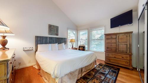 a bedroom with a bed and a flat screen tv at Snowcreek #840 condo in Mammoth Lakes