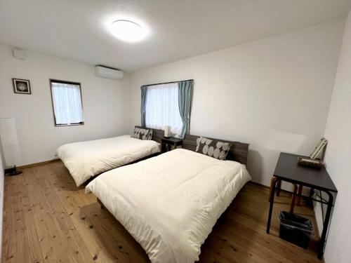 מיטה או מיטות בחדר ב-Shimahaku Aikana