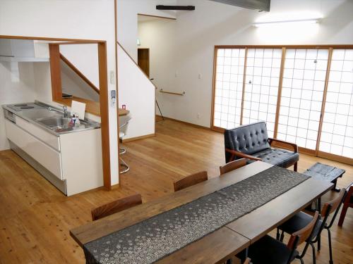 a kitchen and dining room with a table and chairs at Shimahaku Aikana in Tatsugo