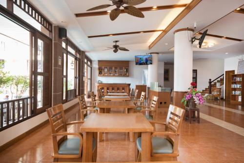 a dining room with tables and chairs and windows at Sunview Place in Pattaya Central
