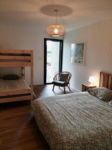 - une chambre avec 2 lits superposés et un lustre dans l'établissement Villa des Dunes, à Gouville-sur-Mer