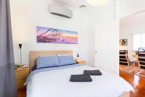a bedroom with a bed with two towels on it at Sunny Home - near West End Cafe's, South Bank & City in Brisbane