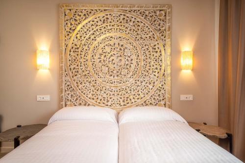 a hotel room with a large bed and a large mirror at Apartamentos SEVILLA ESTE in Seville