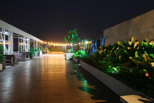 a walkway in a building at night with lights at The Royale Krakatau in Cilegon