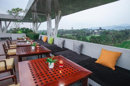 a row of tables and chairs on a balcony at The Royale Krakatau in Cilegon