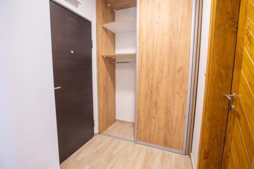 a walk in closet with a glass door at Petar - Jahorinski IZLOG in Jahorina