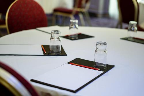 a table with four glasses on top of it at Seagoe Hotel in Portadown