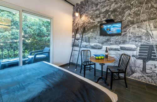 a room with a pool and a table with chairs at Dizengoff Avenue Boutique Hotel in Tel Aviv