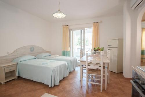 A bed or beds in a room at Le Residenze del Golfo di Orosei