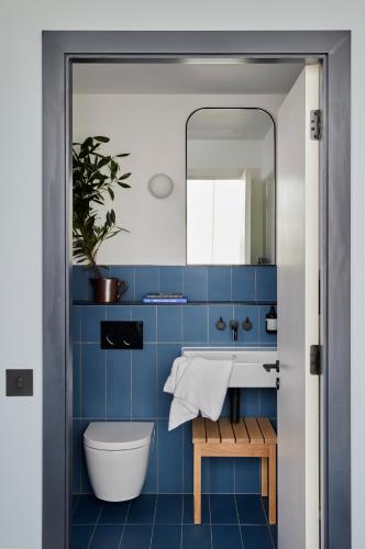 a blue bathroom with a sink and a mirror at Beckett Locke in Dublin