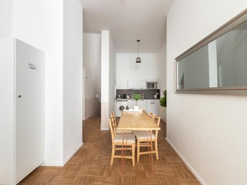 a kitchen and dining room with a table and chairs at limehome Berlin Florastraße in Berlin