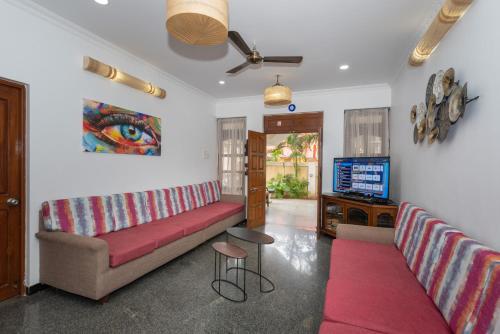 a living room with a couch and a tv at Villa Calangute Phase 1 in Calangute