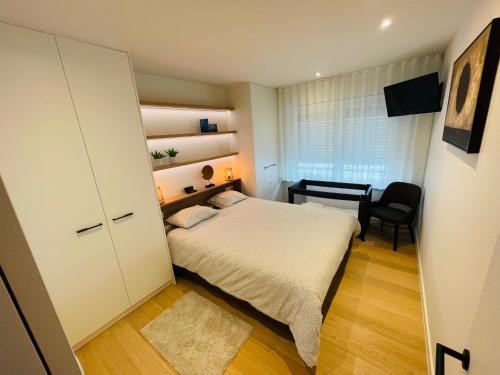 ein kleines Schlafzimmer mit einem Bett und einem Schreibtisch in der Unterkunft Misan Mer in Nieuwpoort
