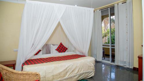 A bed or beds in a room at Karibu Heritage House