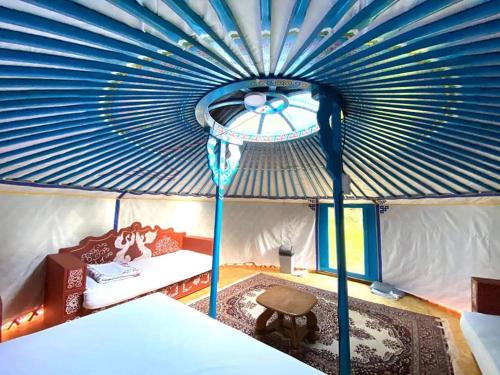 a room with a tent with a bed and a table at Mongolian Yurt Camp in Český Šternberk