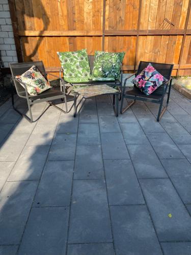 two chairs with pillows sitting on a patio at Gästewohnung Mönchengladbach in Mönchengladbach
