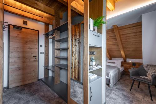 a room with a closet and a bedroom at Hotel Královka in Bedřichov