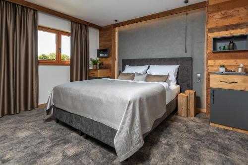 a bedroom with a large bed and a window at Hotel Královka in Bedřichov