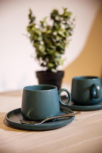 two coffee cups sitting on top of a table at The Phoenix Boutique Hotel in Yerevan