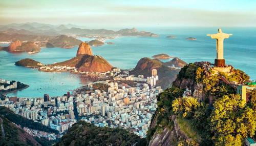 a view of a city with a cross on a mountain at Rede Reserva Copacabana in Rio de Janeiro