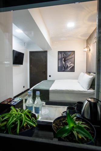 a bedroom with a bed and a table with a kitchen at The Phoenix Boutique Hotel in Yerevan